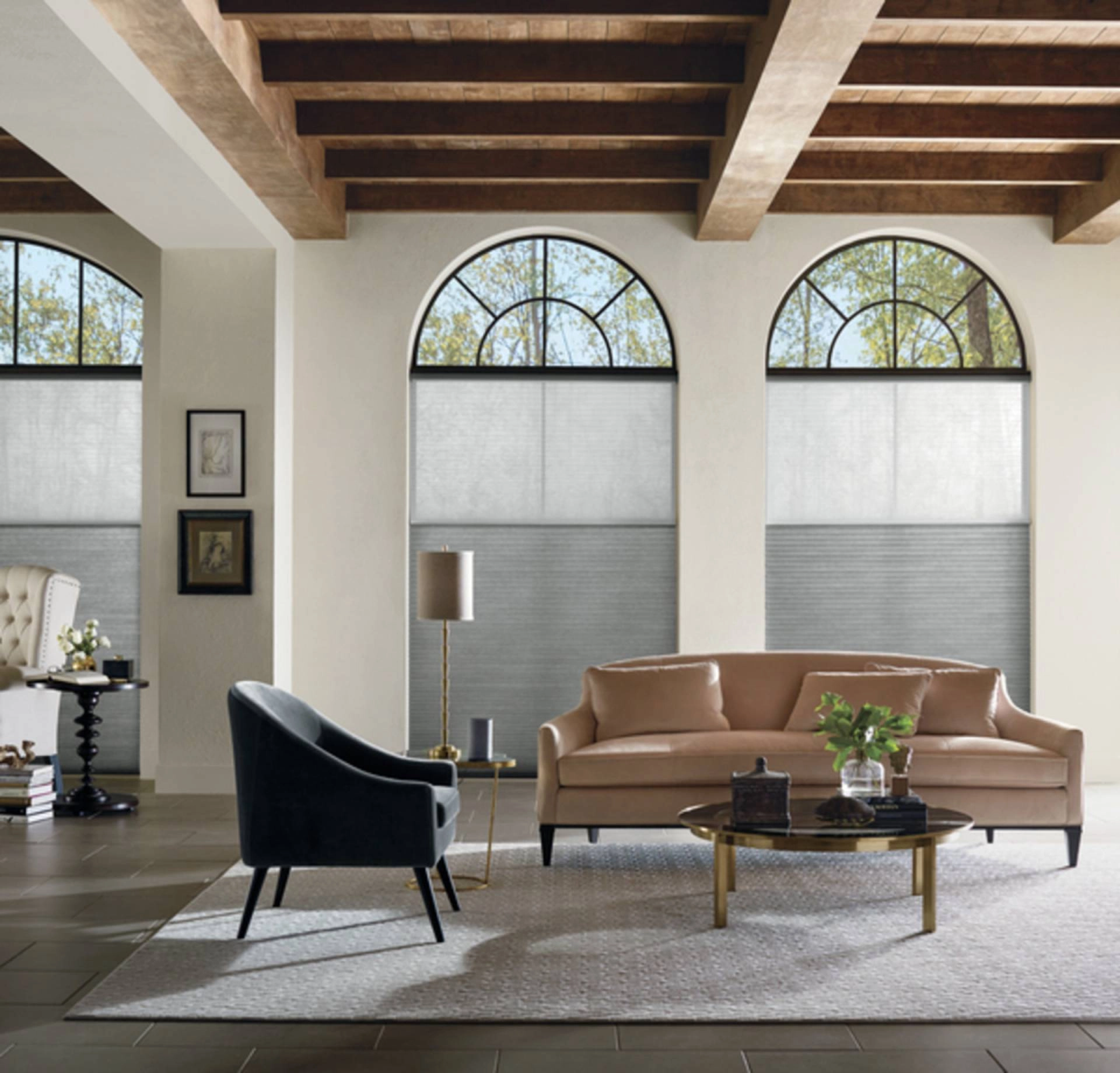 Motorized Hunter Douglas Duette® Cellular Shades on arched windows in a living room.