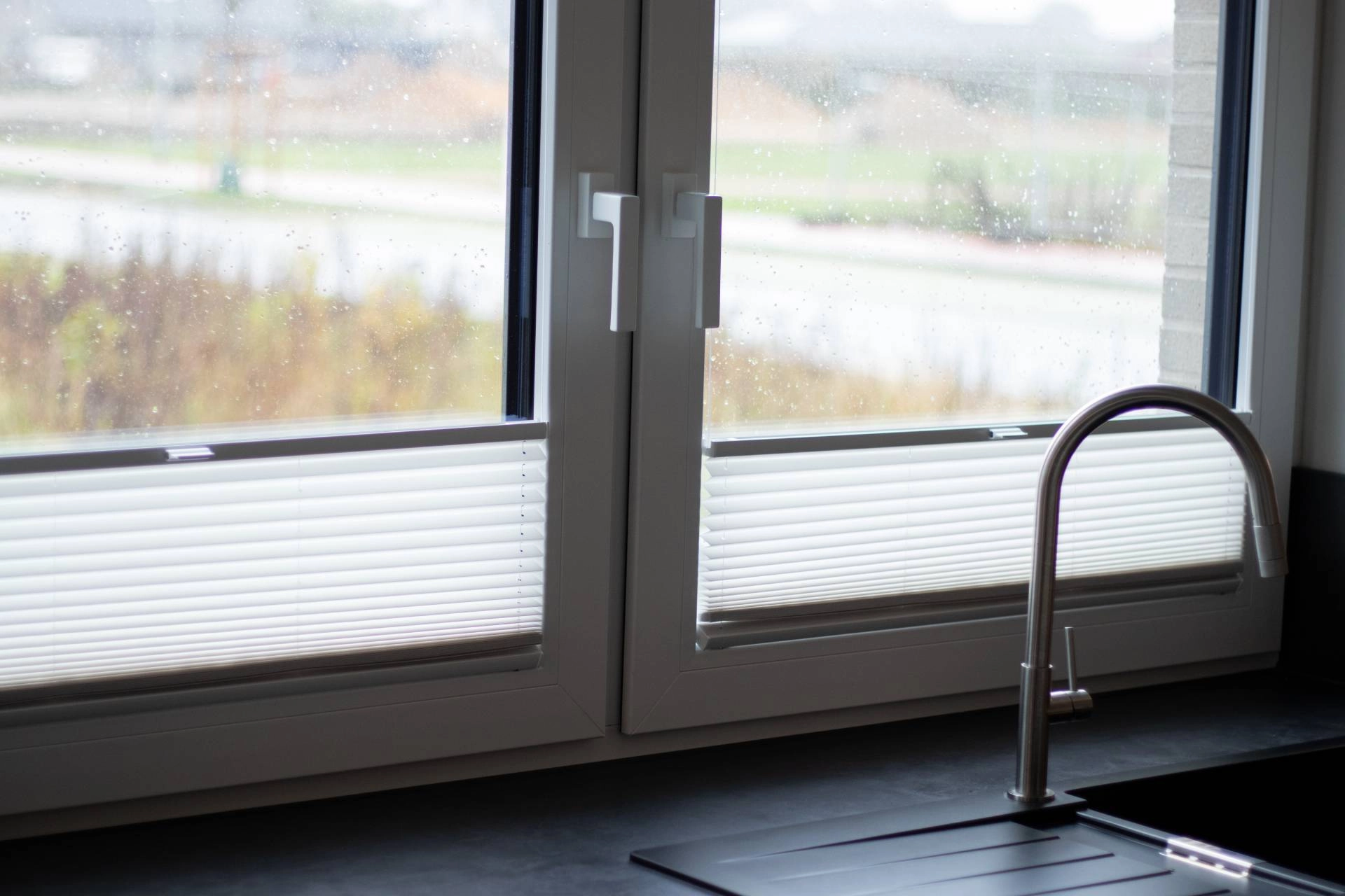 Cellular shades on a kitchen window behind a sink near O’Fallon, MO