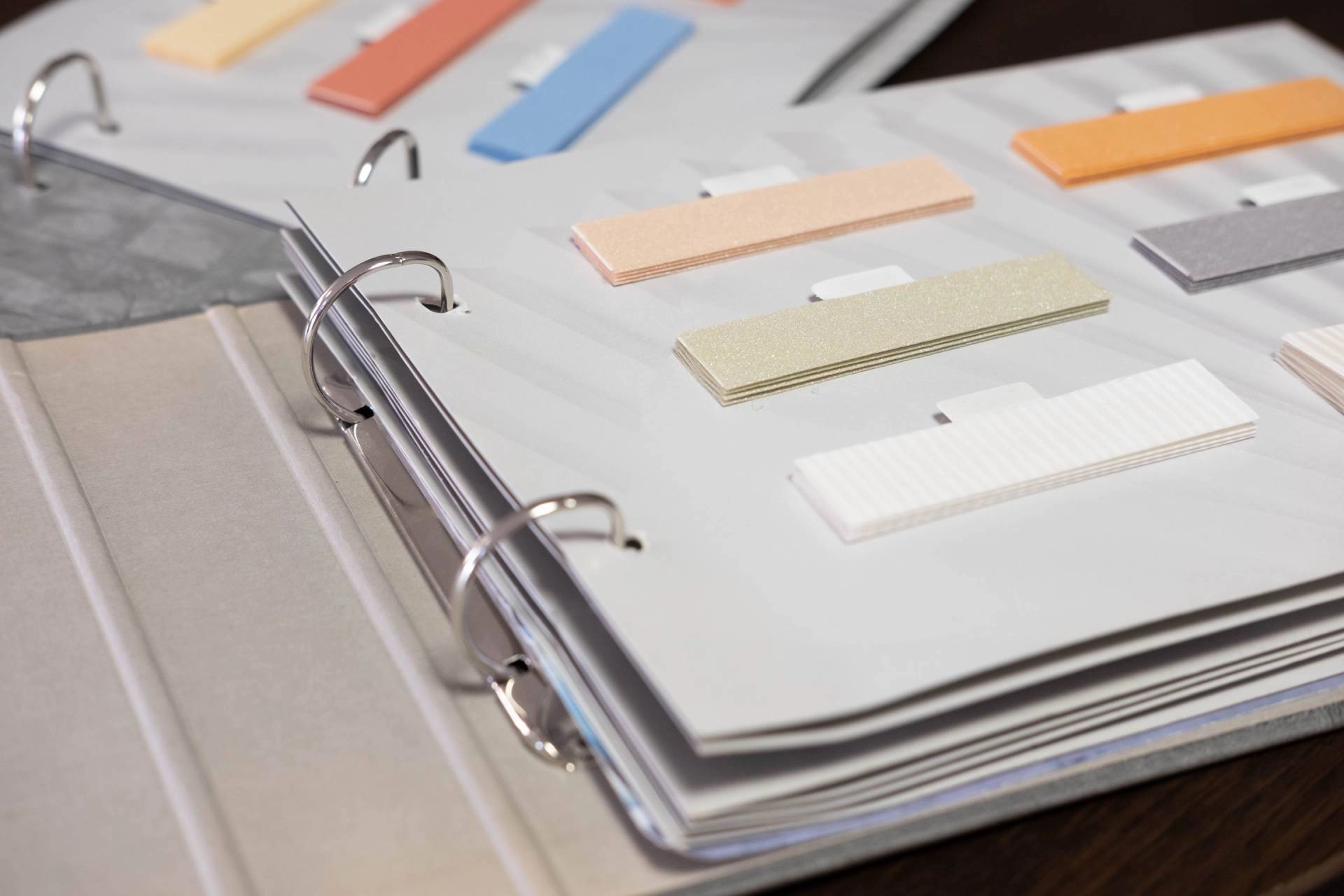 A binder collection featuring various colors for cellular shades that homeowners can choose from