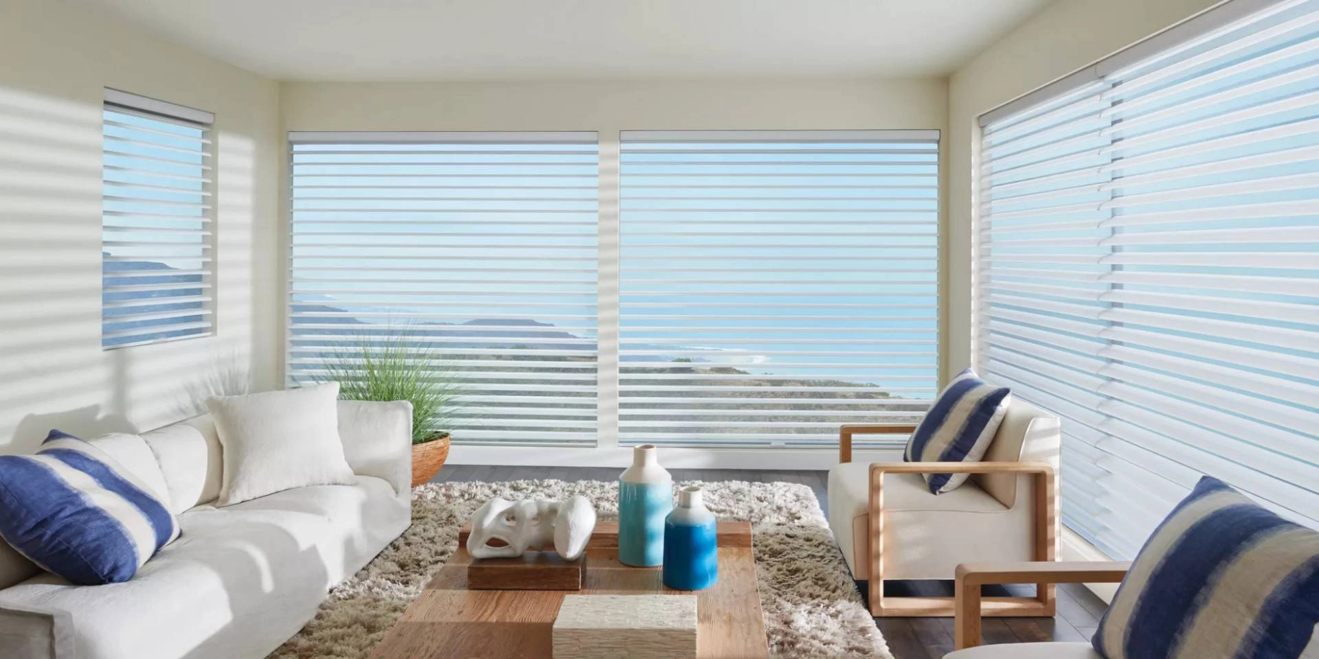 Hunter Douglas Silhouette® Sheer Shades as custom sunroom shades on a window, overlooking a gorgeous view