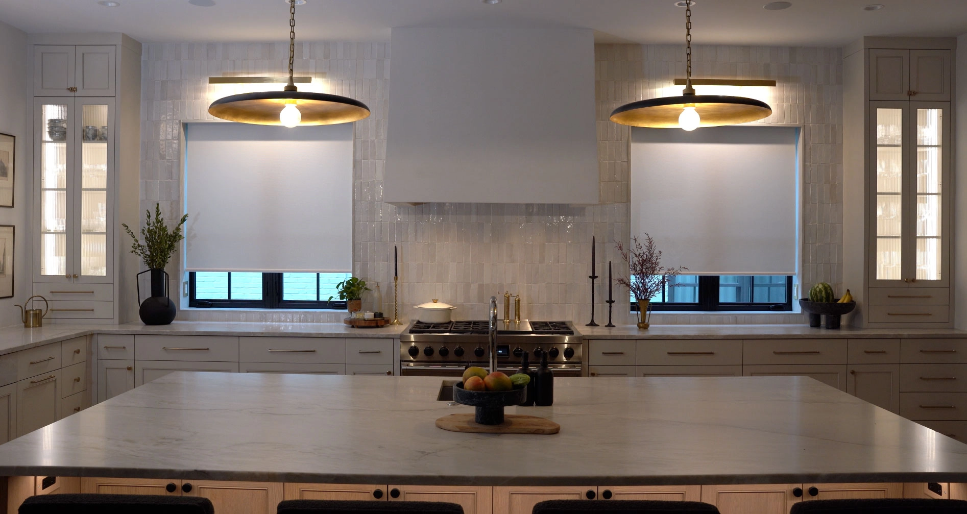 A kitchen with two windows featuring Hunter Douglas shades.