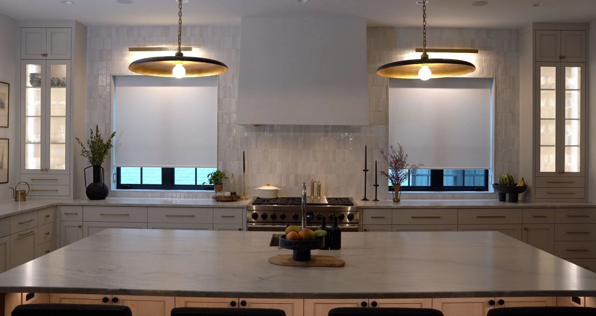 A kitchen with two windows featuring Hunter Douglas shades.