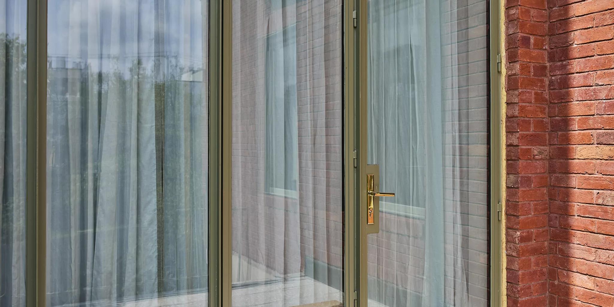 Carole Fabrics privacy drapes view from the outside of a home
