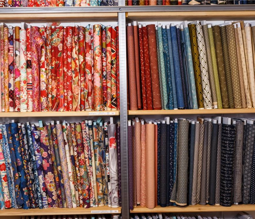 Image of many custom drapery fabric bolts, both colors and patterns, for individuals.