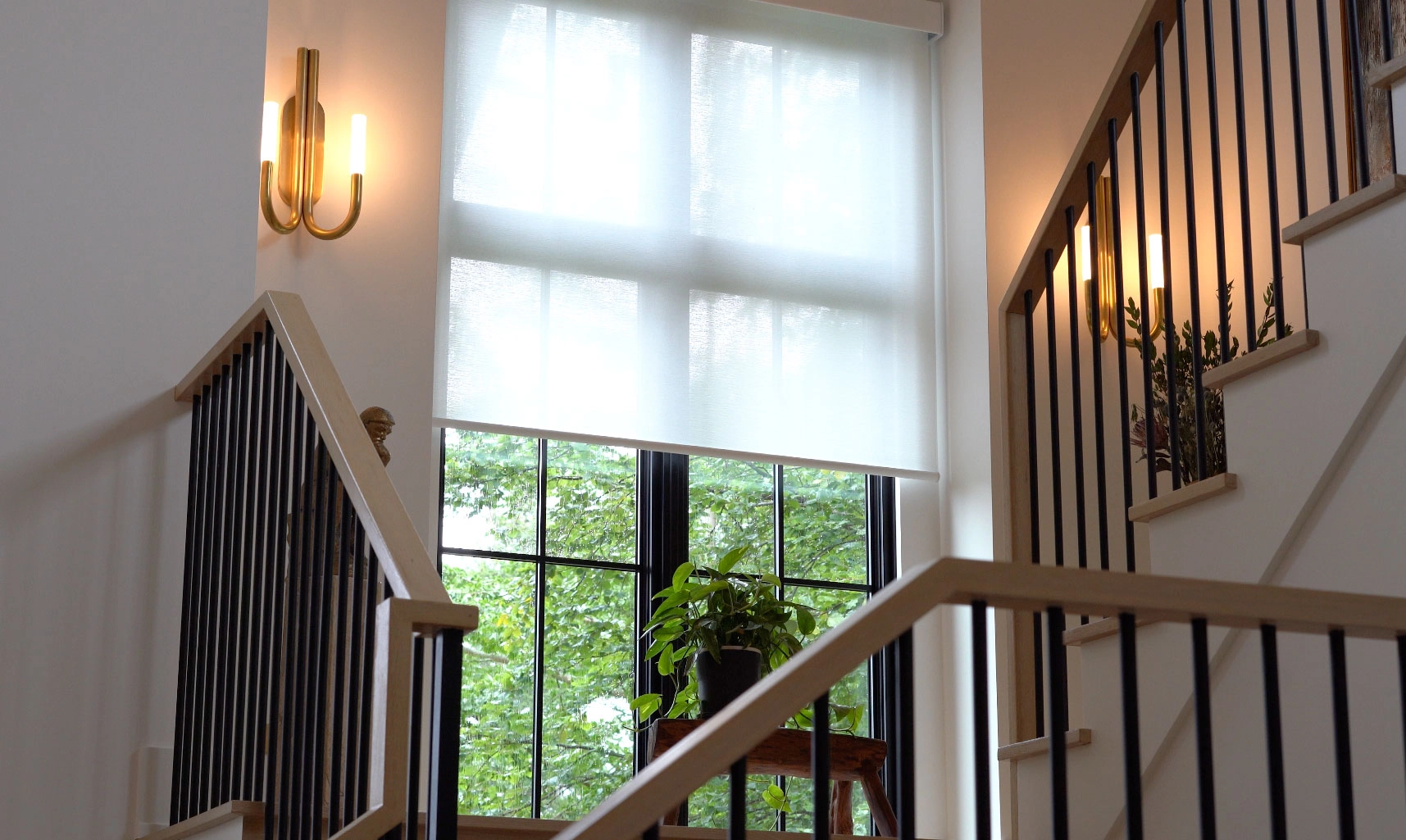 Window with Hunter Douglas fashions amidst a staircase in a home.
