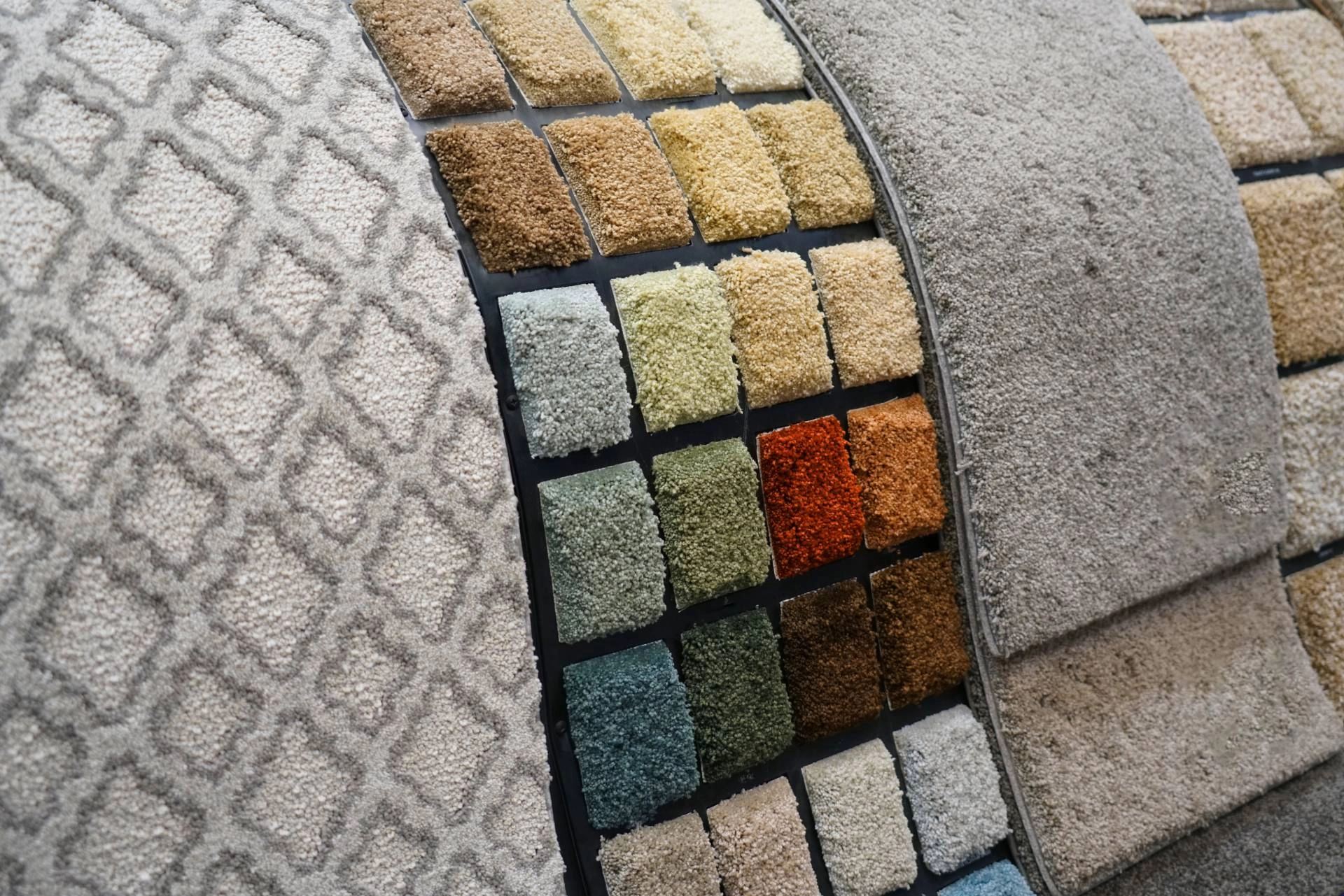A collection of various types of new carpeting styles, colors, and patterns for a flooring renovation