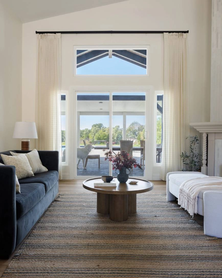 Ripplefold drapery in a sunlit room with hardwood floors