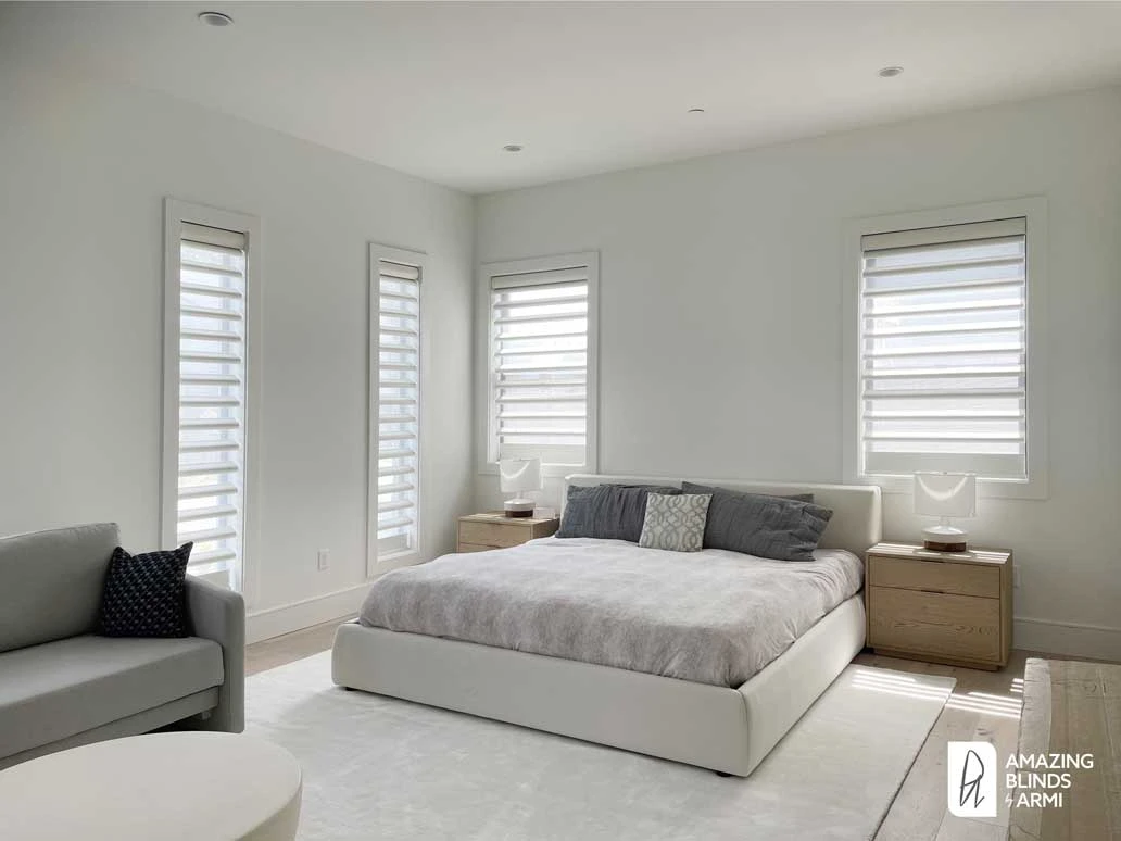 Bedroom windows with Hunter Douglas shades.