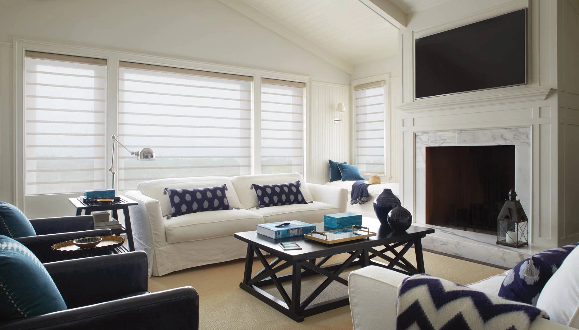 Hunter Douglas Roman shades covering multiple windows in a traditional living room near Youngstown, OH.