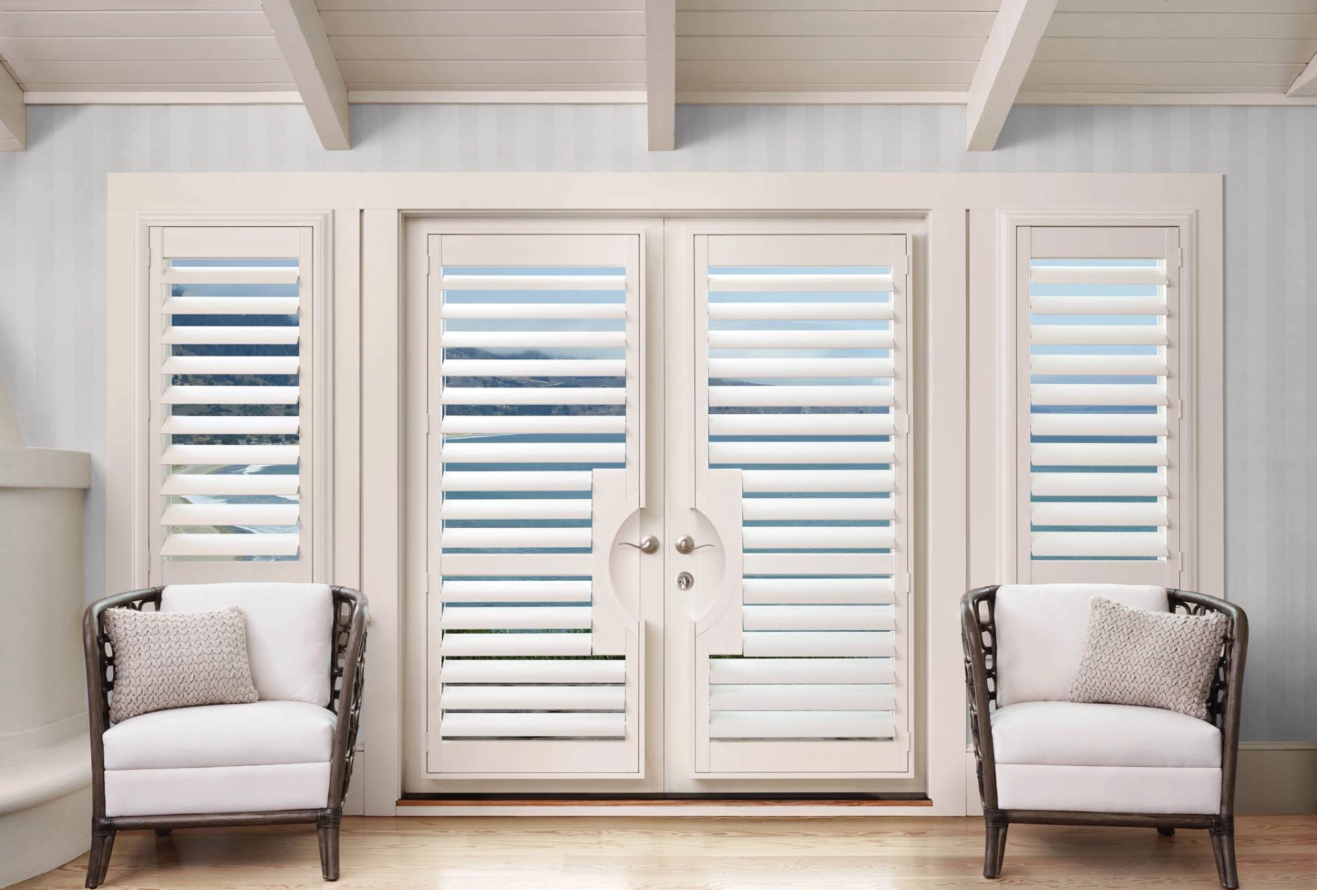 Hunter Douglas shutters covering French doors in a bedroom near Norwalk, CT