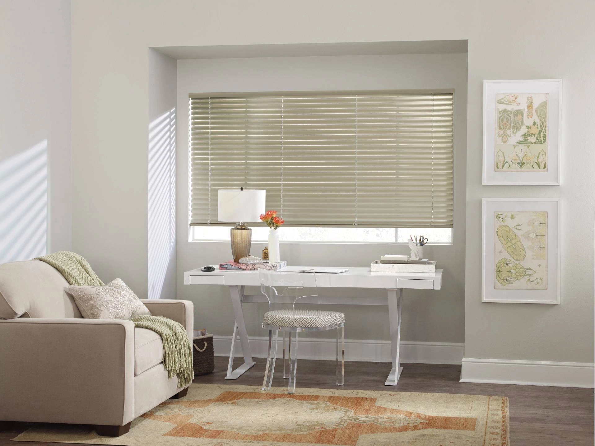 Narrow blinds in a posh home office with a loveseat and desk