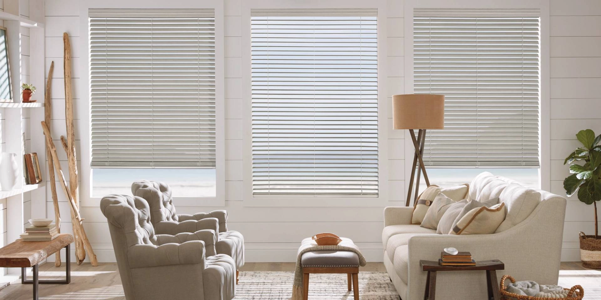 Hunter Douglas faux wood blinds on three windows in a bright and airy living room near Honolulu, HI