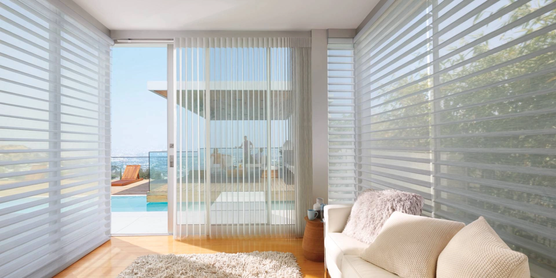 Hunter Douglas Silhouette® Sheer Shades as light control shades on large windows, overlooking a pool
