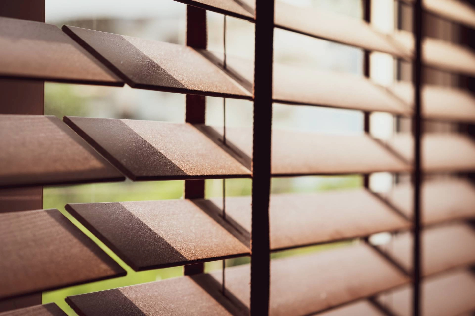 Custom wood blinds covering an angled window near Temecula, CA