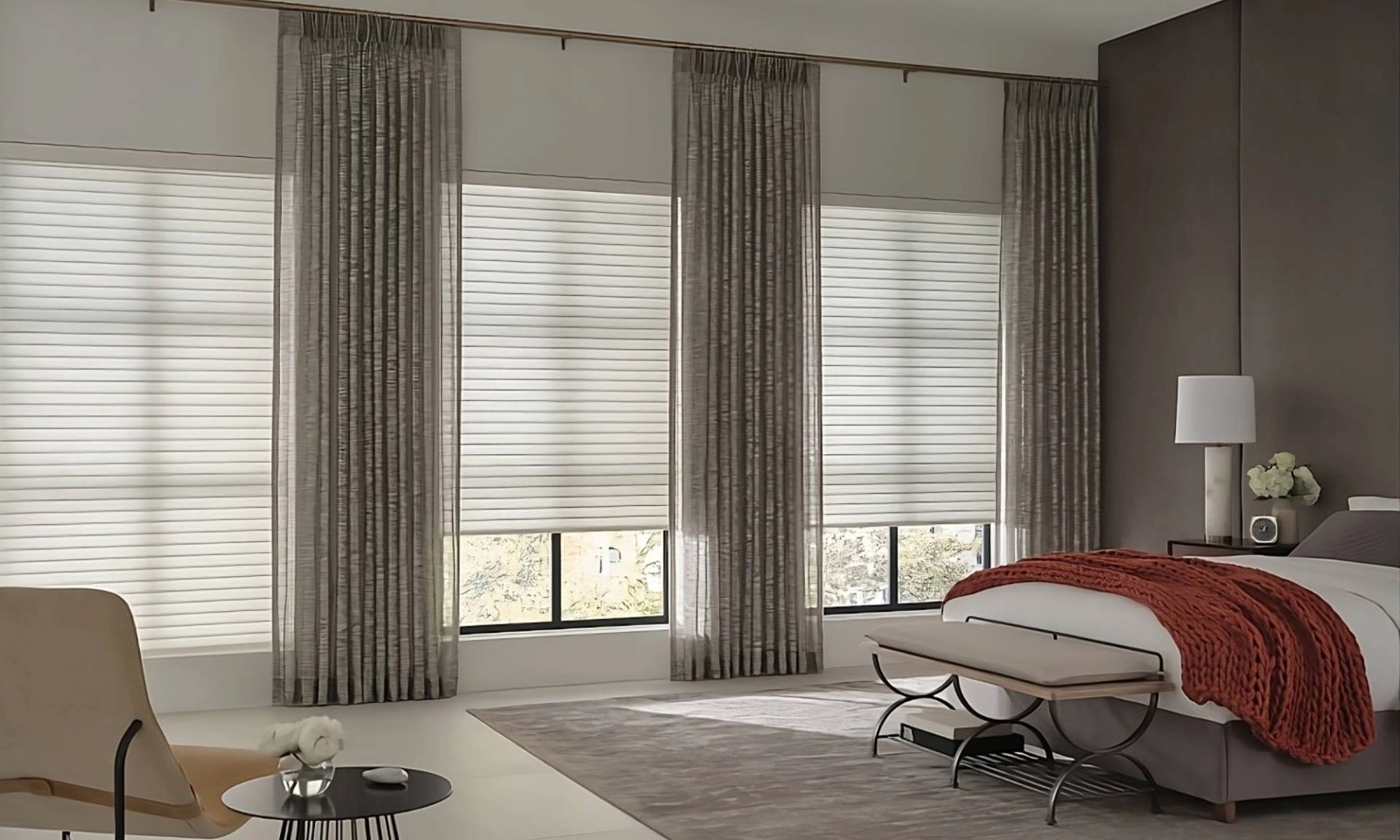 Chic Hunter Douglas Sonnette® Roller Shades as room-darkening shades in a stylish primary bedroom