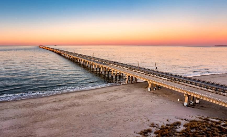 An aerial photo of Chesapeake Bay Bridge Tunnel in Virginia during a beautiful sunset near the Waterside District