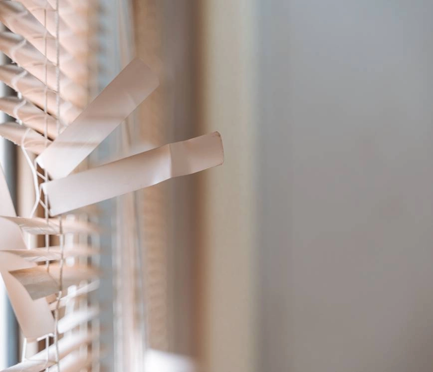 An image of window blinds in need of repair inside a residential home near Providence, RI