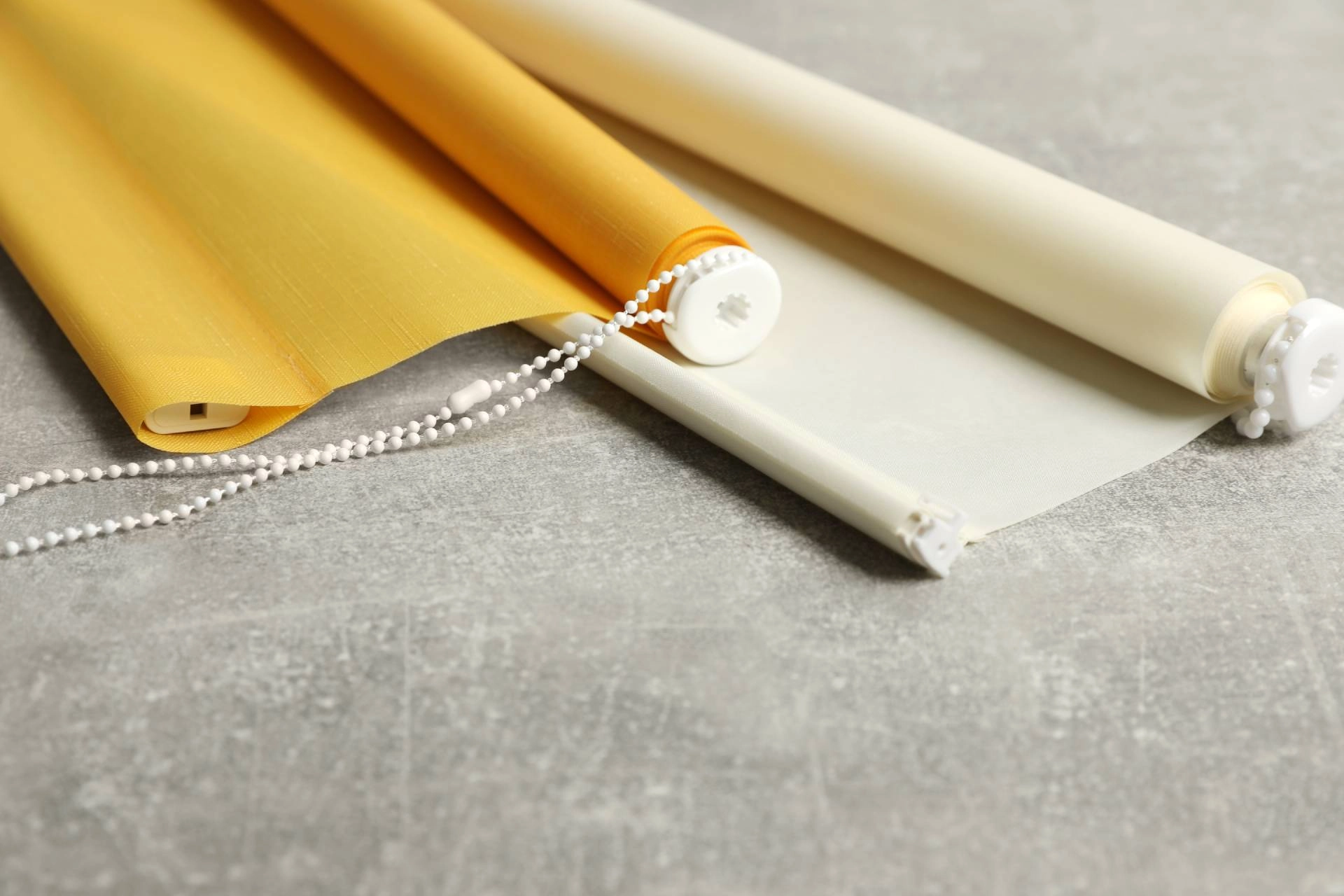 A yellow custom roller shade displayed on a countertop near Freeland, MI