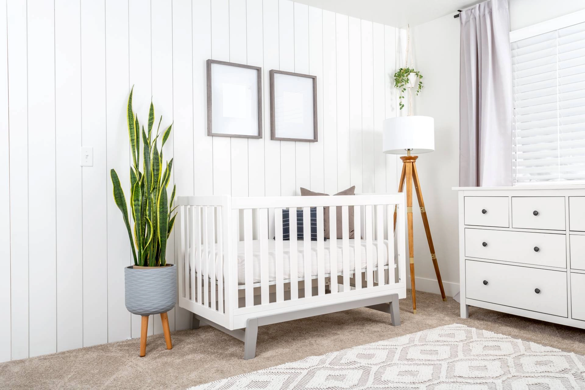 Cozy nursery window treatments with layered drapes to provide room-darkening enhancements for naptime