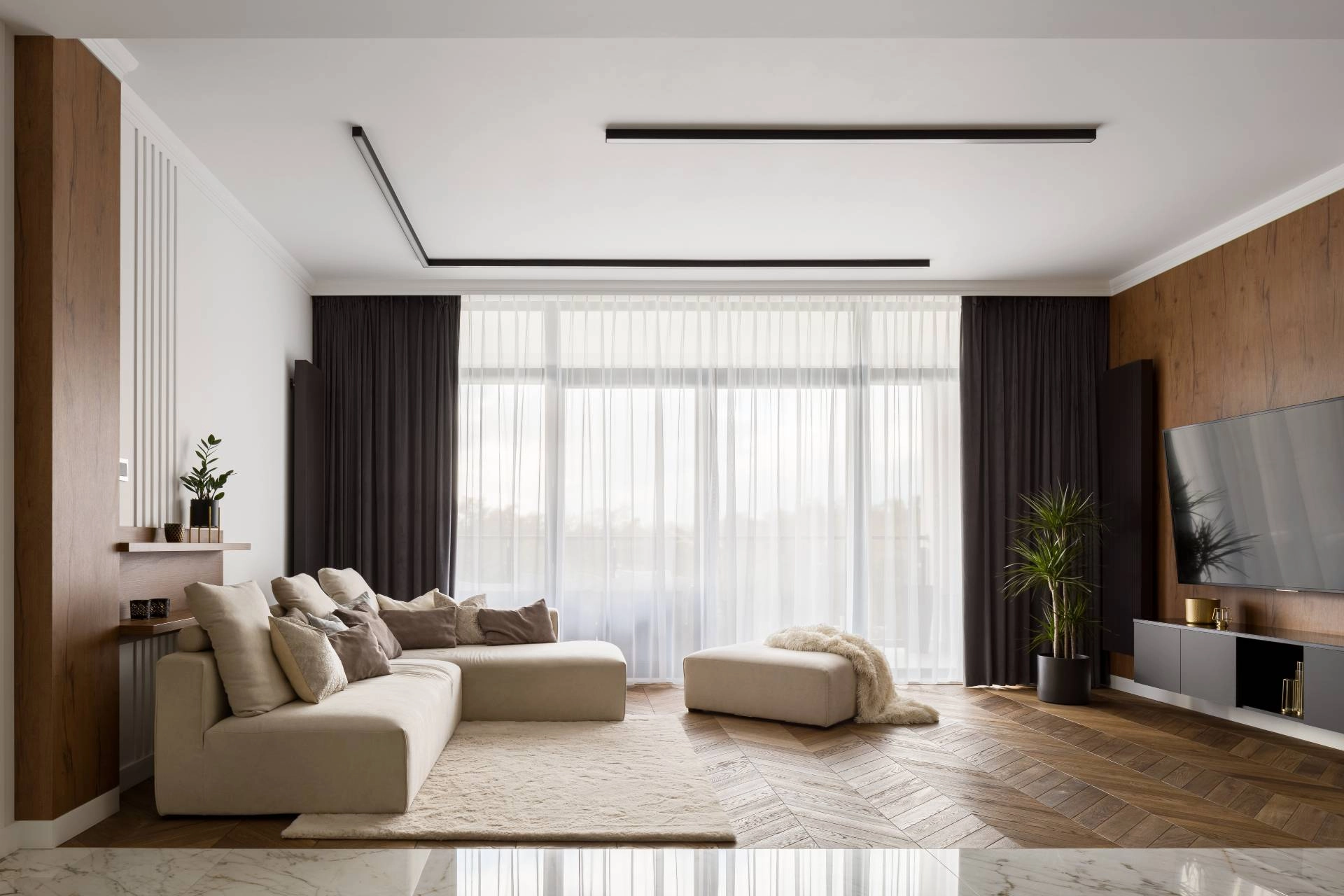 Black and beige living room with layered dark drapes and sheers with beige accents throughout