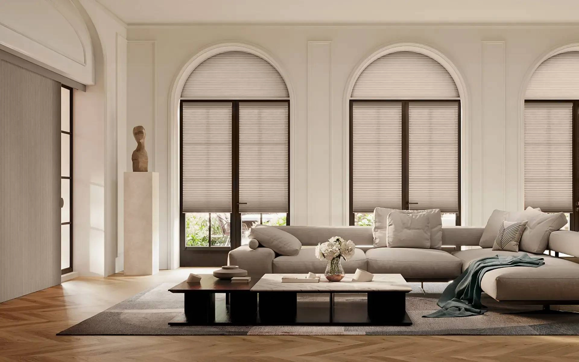 Custom cellular shades on arched windows in a contemporary living room.