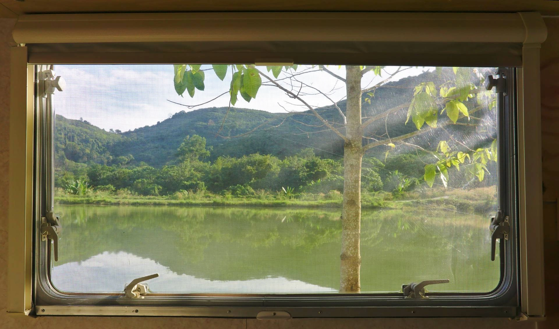 A lake in summer as viewed from the inside of an RV through a window near Barrington, Illinois (IL)