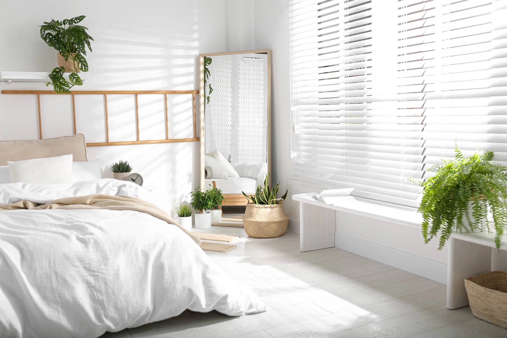 Modern bedroom blinds in a large space, decorated with light and white accents and houseplants