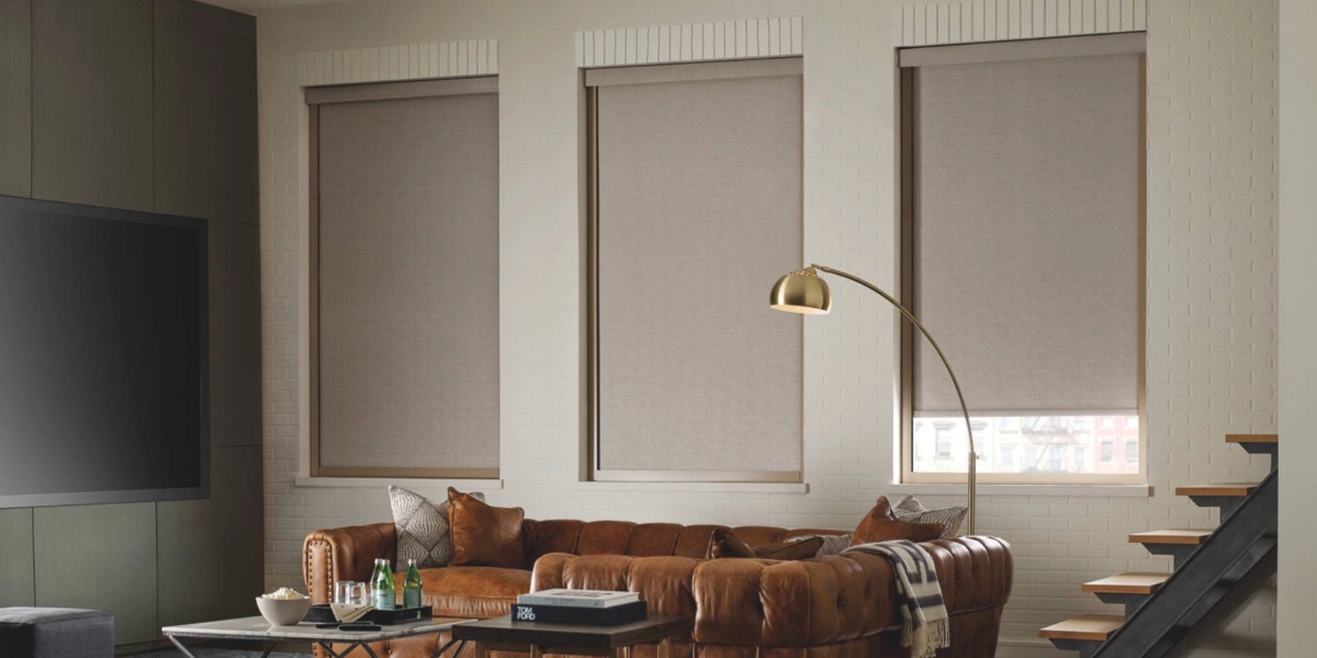 Hunter Douglas Designer Roller Shades as room-darkening window treatments in a cozy living room