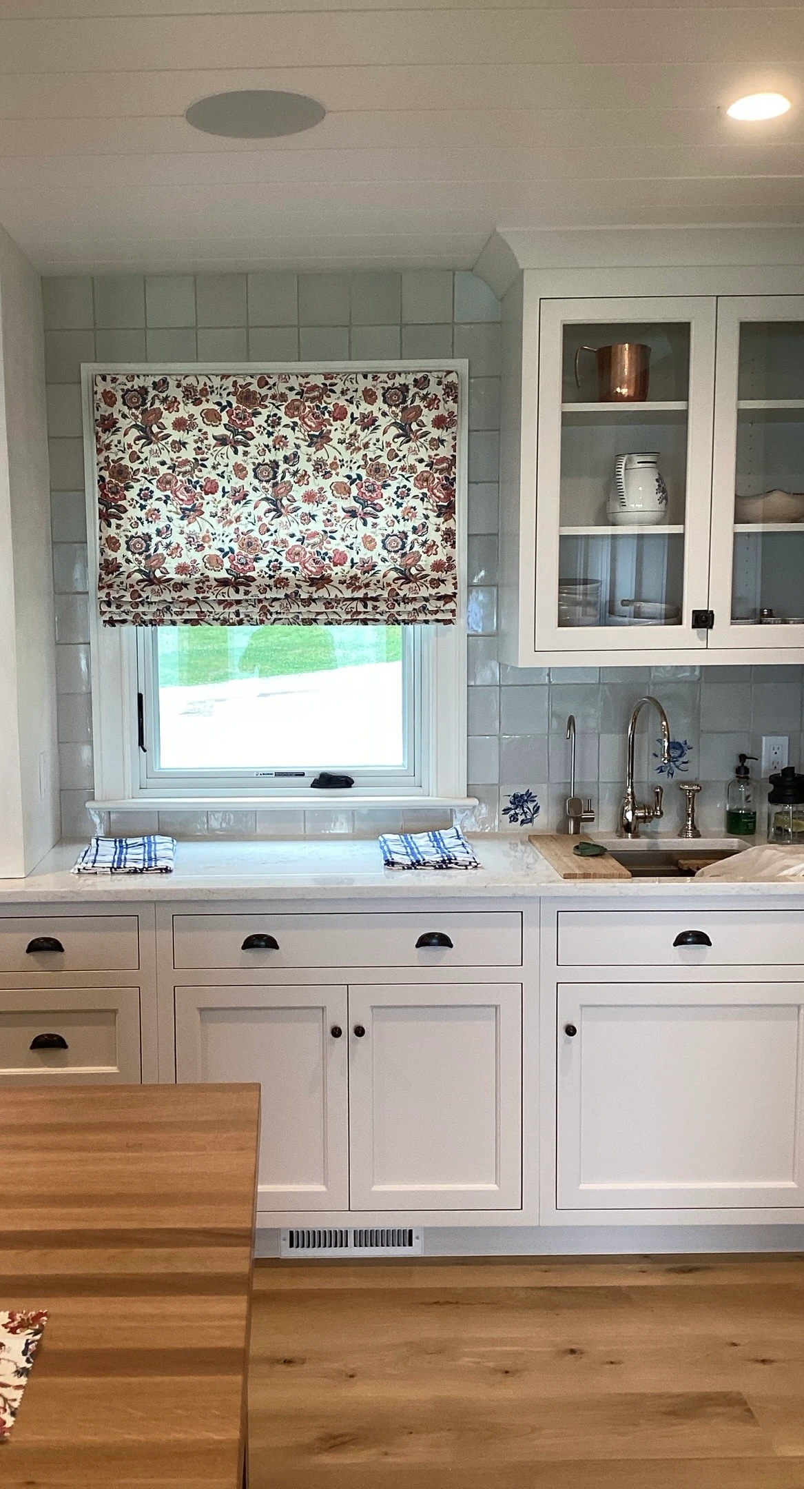 Kitchen window with shades.