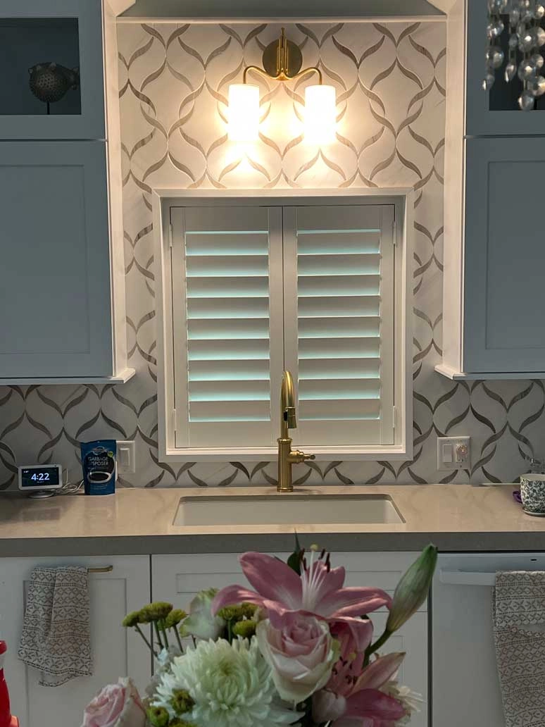 Shutters above a kitchen sink.