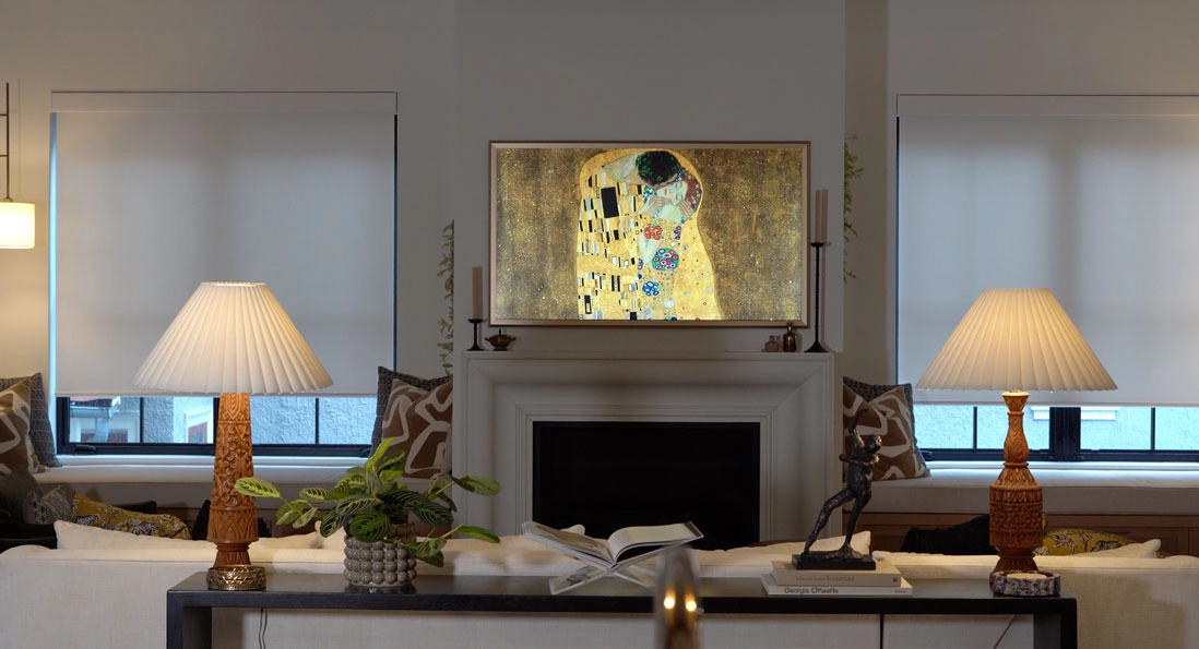 A living room with two windows featuring Hunter Douglas shades.