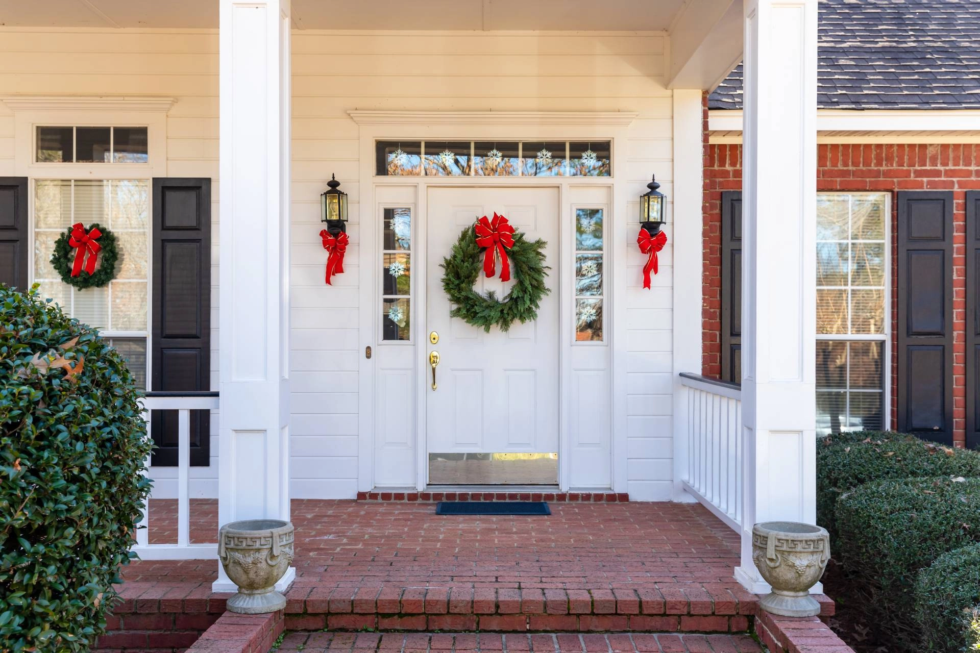 Front porch of a home with a front door and sidelight windows during Christmas near Flower Mound, TX