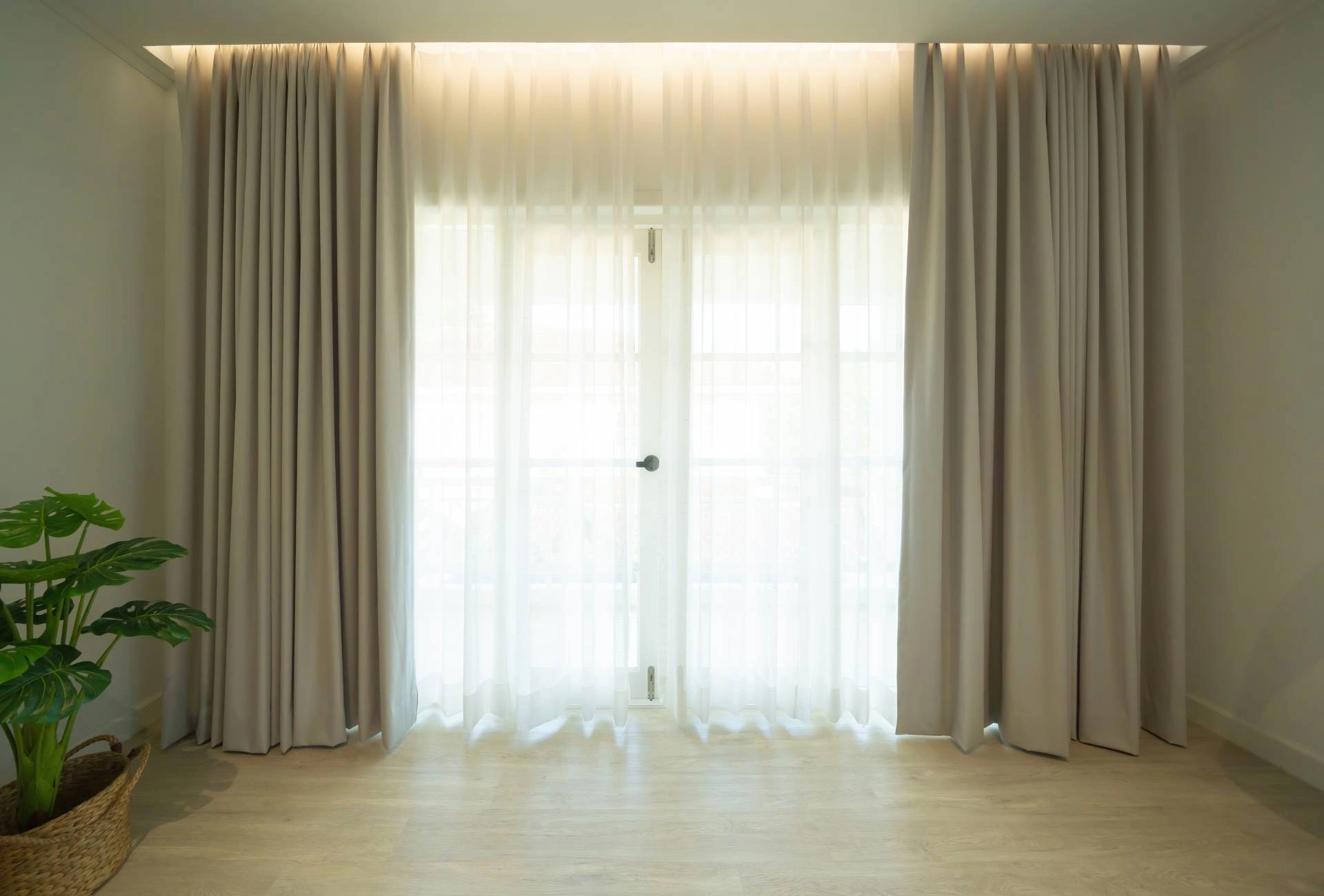Custom olive green drapery with white sheer drapes in a modern living room near Flower Mound, TX