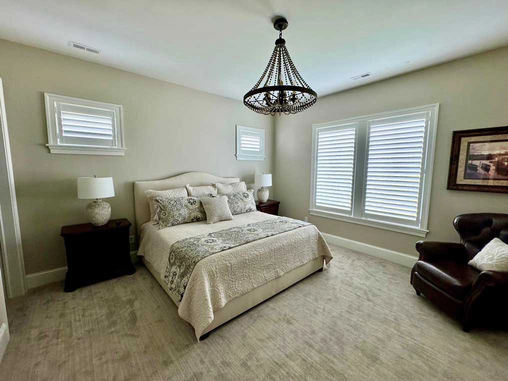 Bedroom windows with Hunter Douglas blinds.