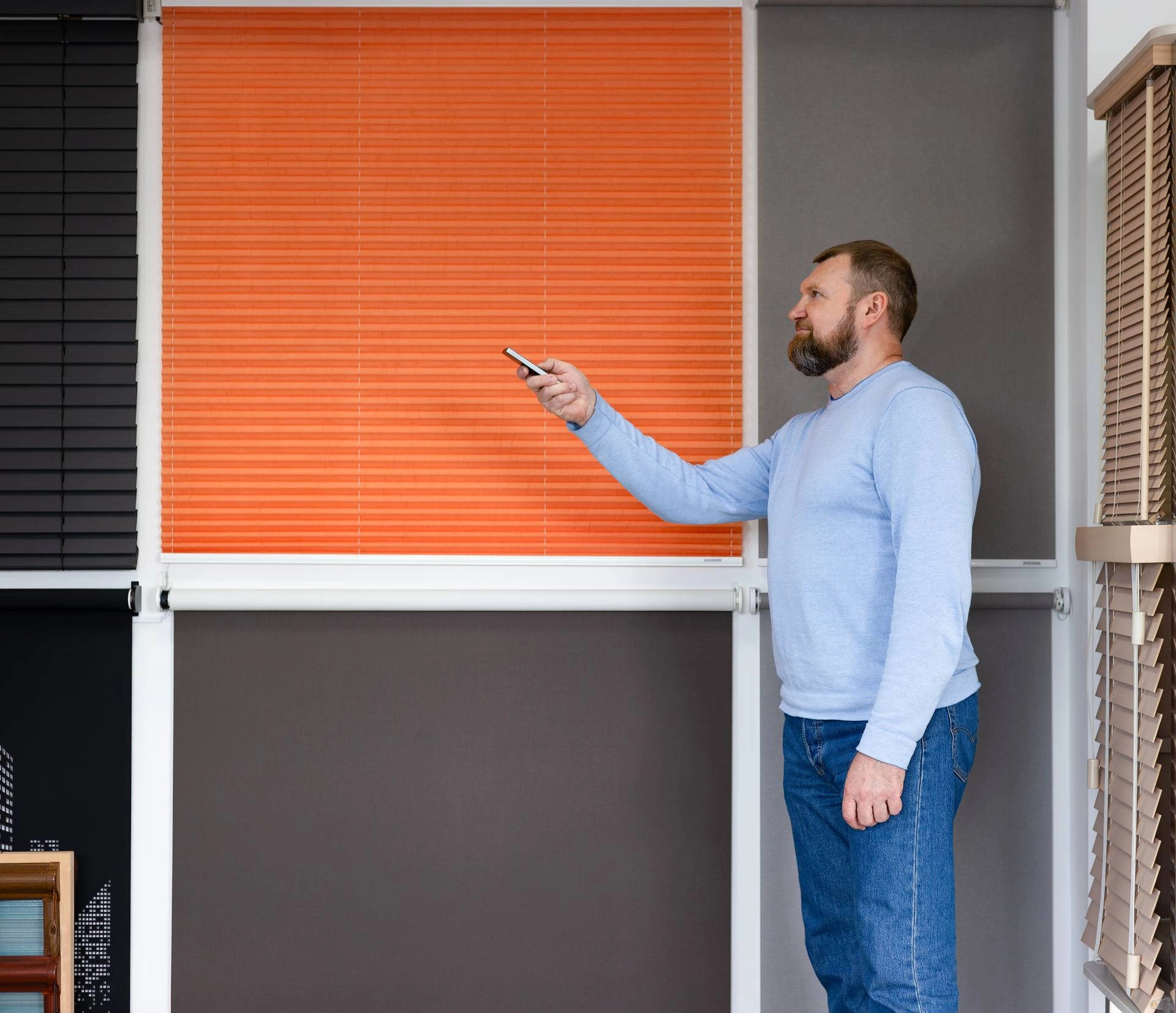 Someone testing several automated window treatments with a remote near Santa Rosa, California