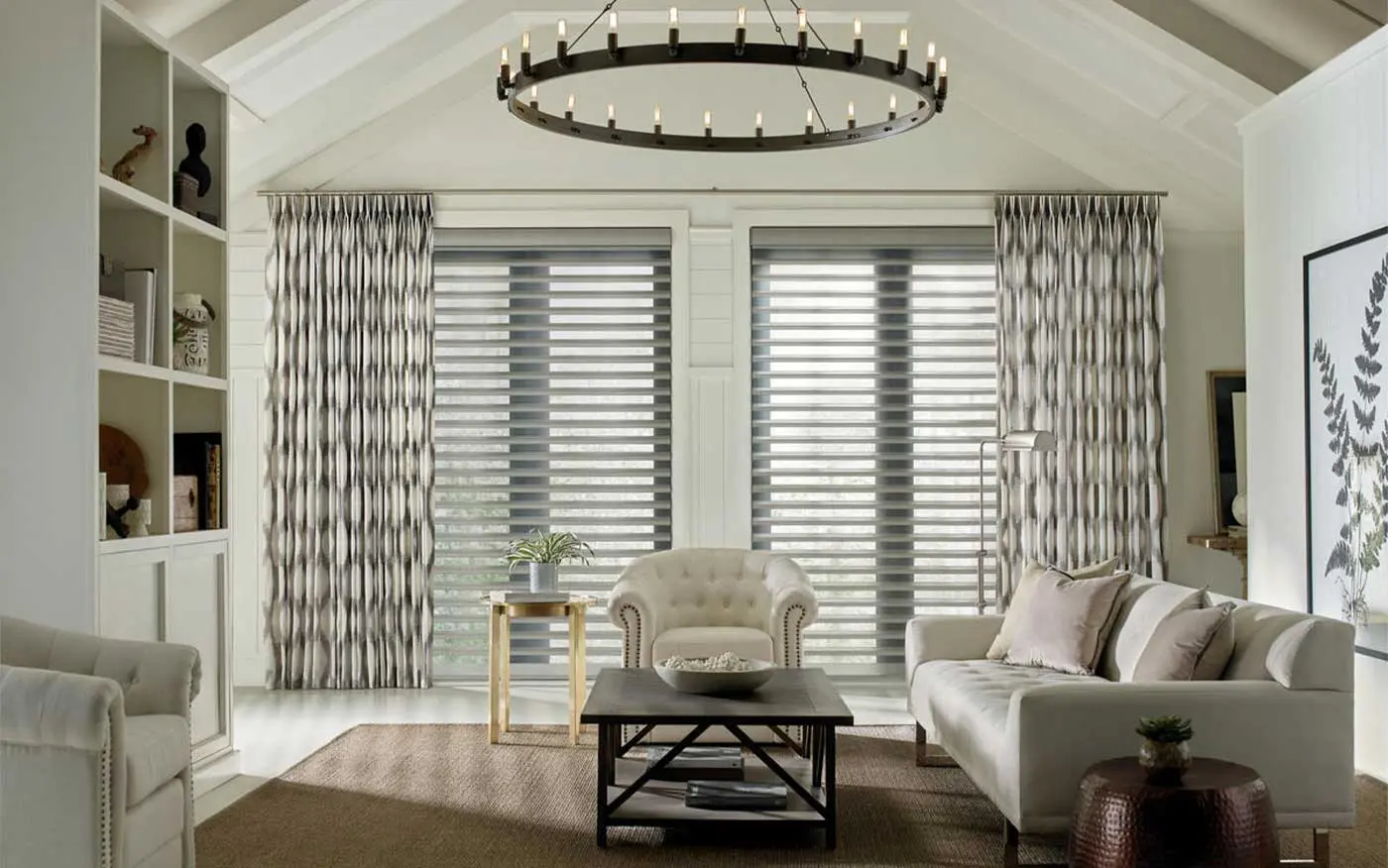 A living room with large windows with Hunter Douglas blinds.