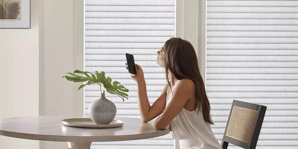 Woman operating her window treatments with her phone.