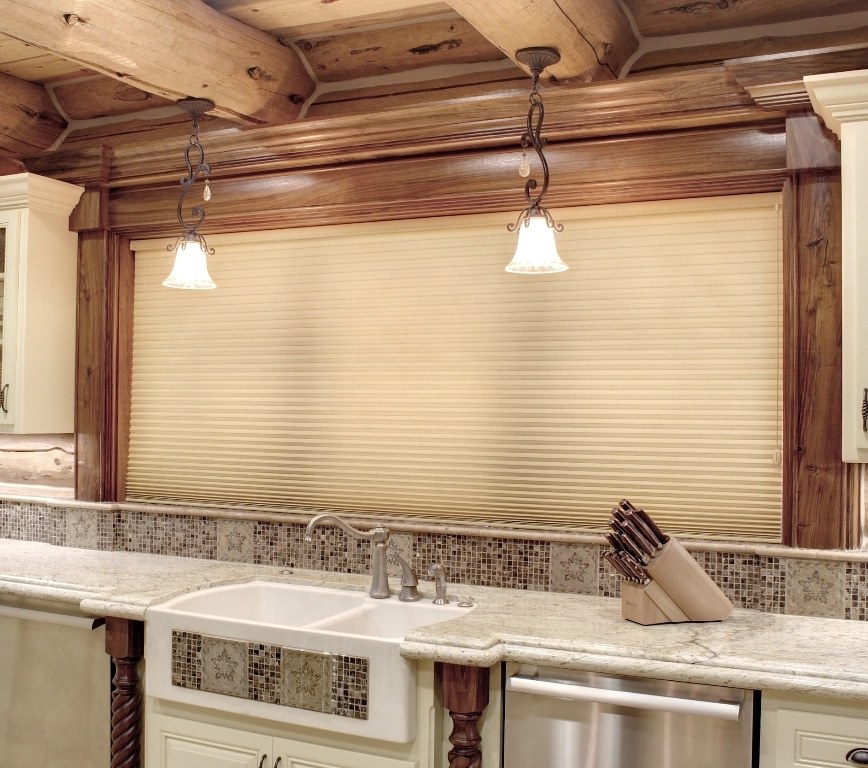 Kitchen window above the sink featuring Hunter Douglas shades.
