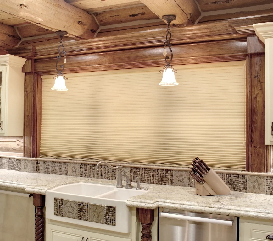 Kitchen window above the sink featuring Hunter Douglas shades.