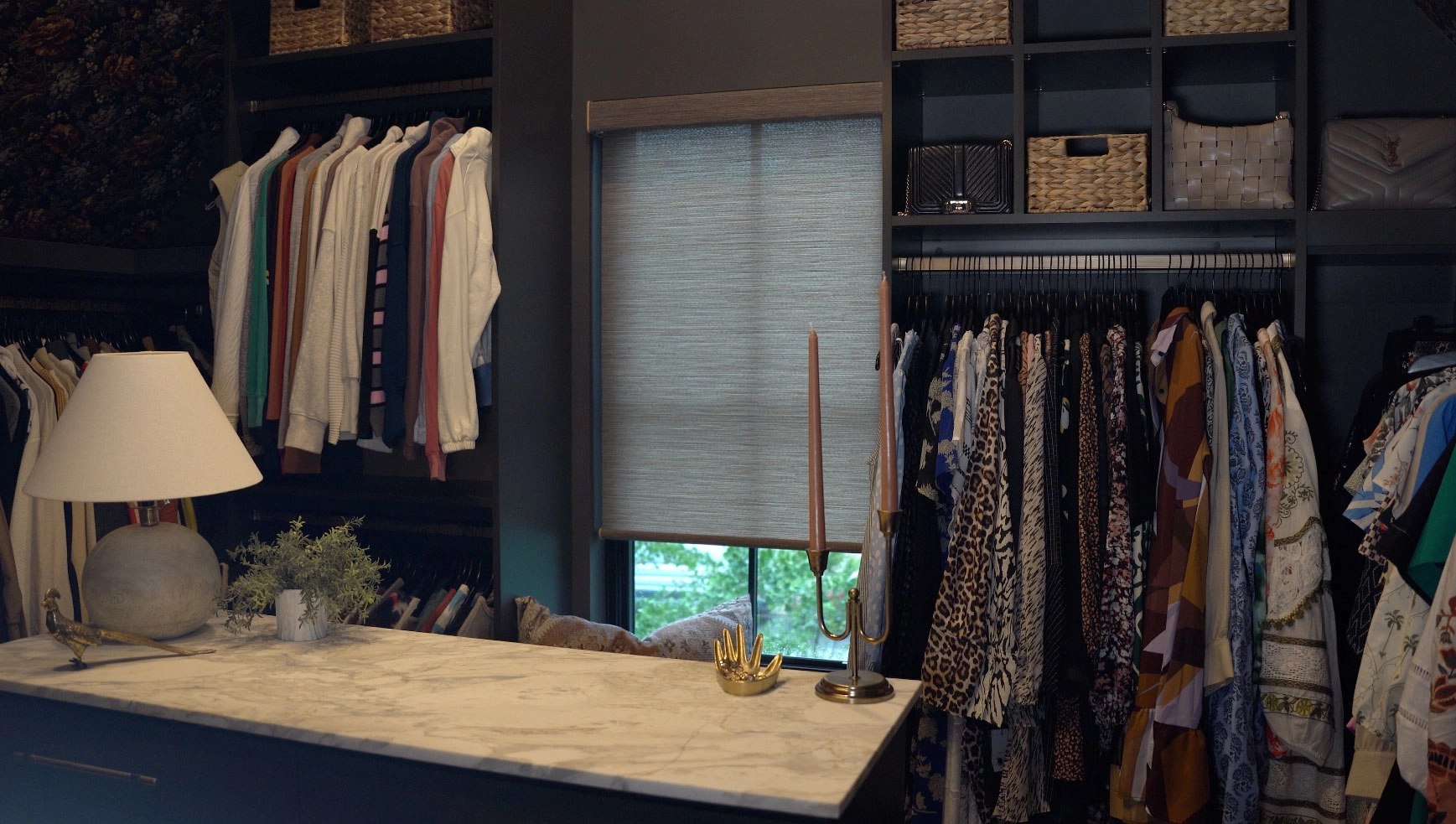 A window in a wardrobe room featuring Hunter Douglas shades.