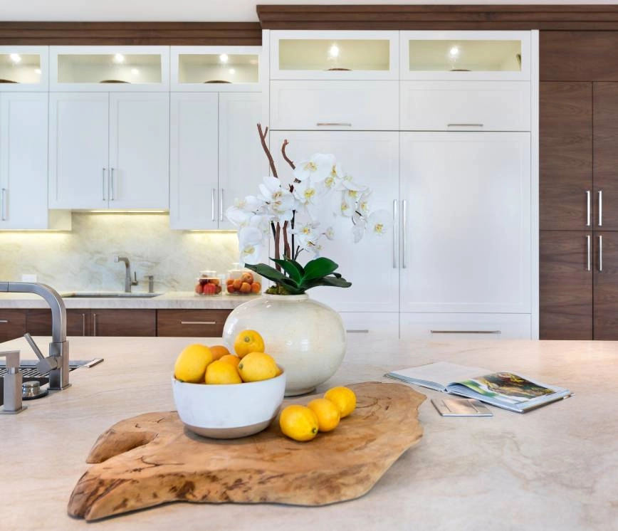 Staged kitchen with cabinets, island, and different accessories near Fort Myers, FL