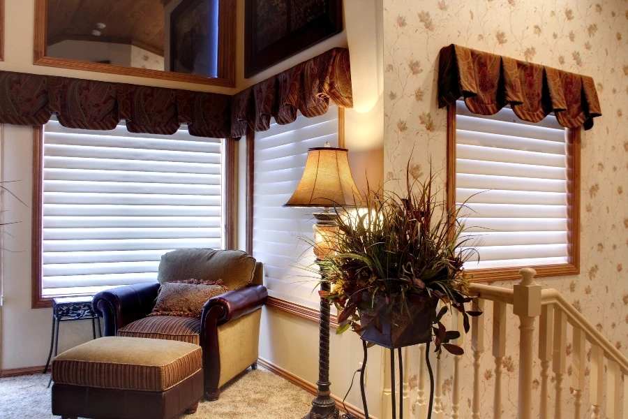 Living room with windows featuring Hunter Douglas blinds.