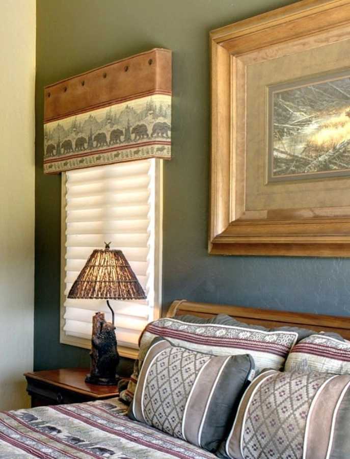 A bedroom window with Hunter Douglas blinds.