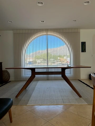 Vertical window covering on arch window