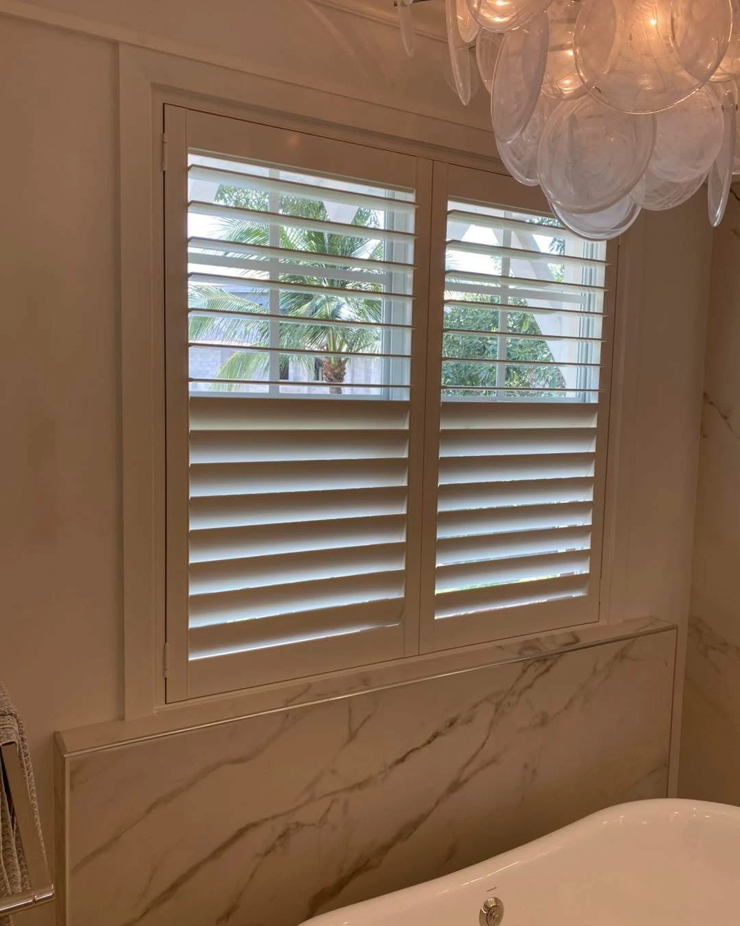 Shutters above a bath tub.