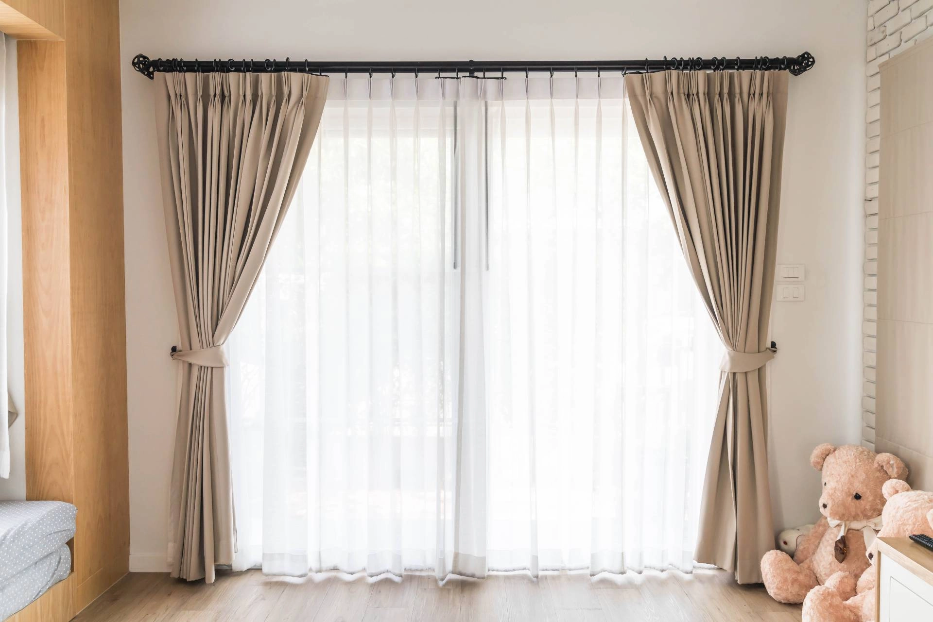 A set of curtains in a child's bedroom with stuffed animals and wood detailing near Apex, NC