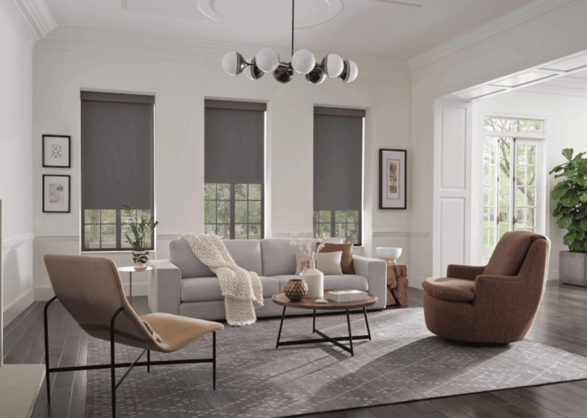 Gray roller shades on three windows in a modern living room with a light gray sofa near Springfield, MO