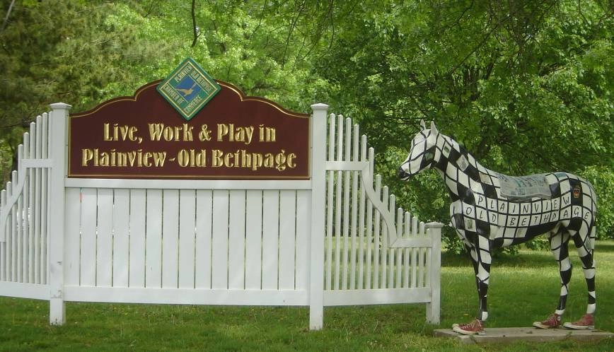 Plainview-Old Bethpage sign beside the statue of a horse near Plainview, NY.