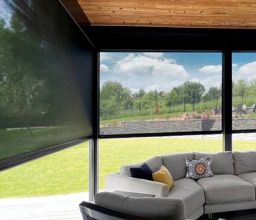 Outdoor screen shades blocking light on a covered patio.