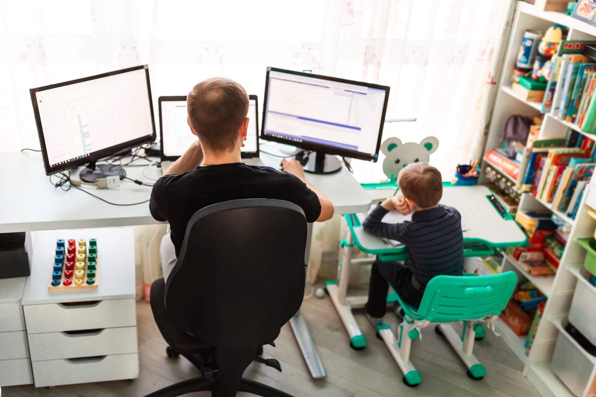 A father and son working in a home office near Albuquerque, New Mexico (NM)